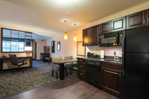 Spacious front room with dark wood cabinets and funiture