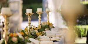 Elegant outdoor reception table with gold candle sticks