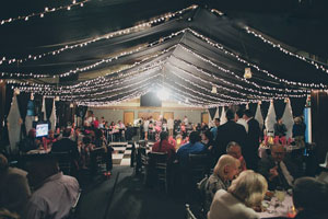 Outdoor reception at night with canopy made of white string lights